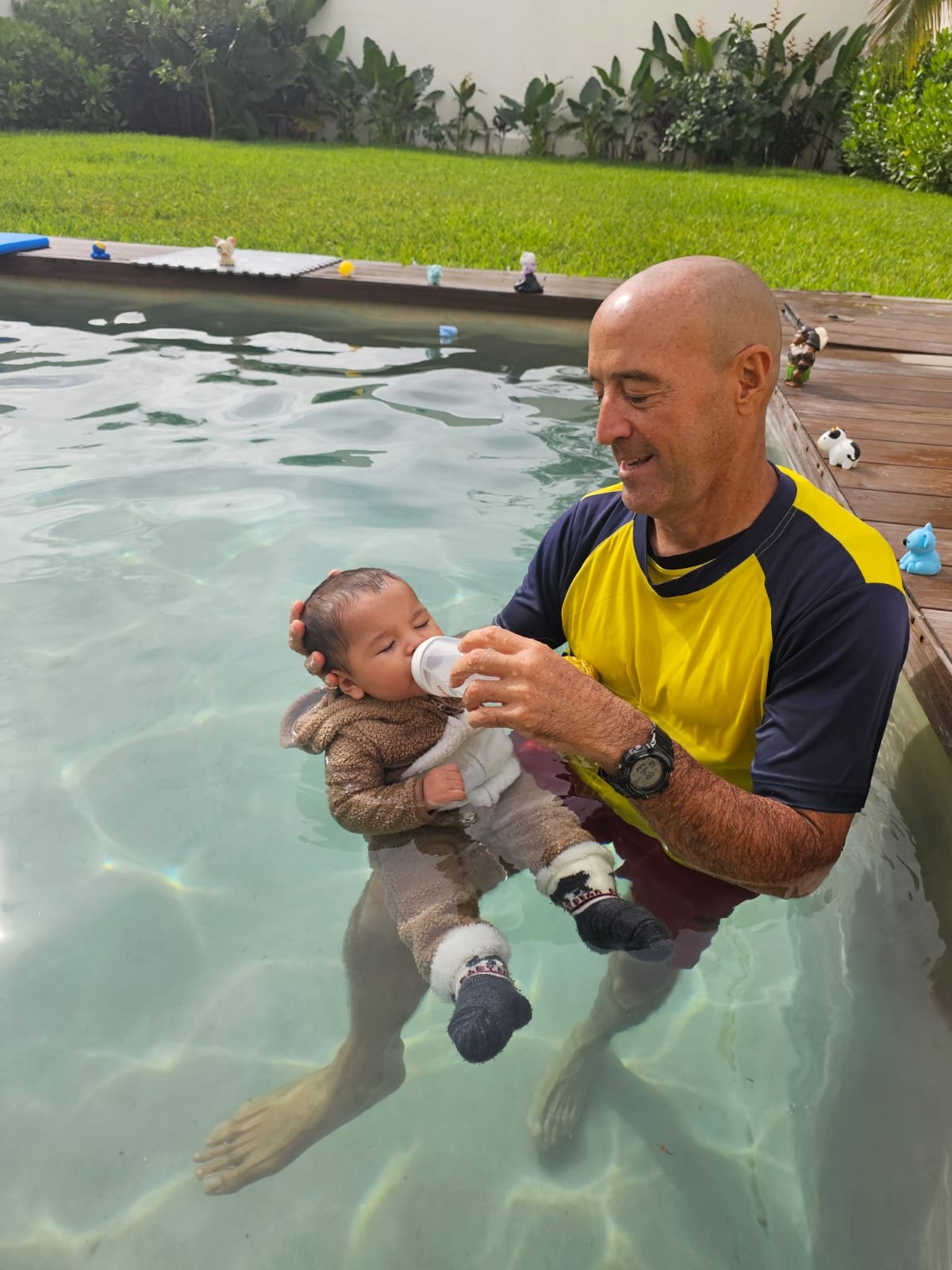 Toddler swimming happily and safely achieving aquatic autonomy